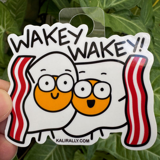 Cute vinyl Wakey Wakey Eggs and Bakey Sticker – cartoon breakfast decal with eggs and bacon by Kalirally.