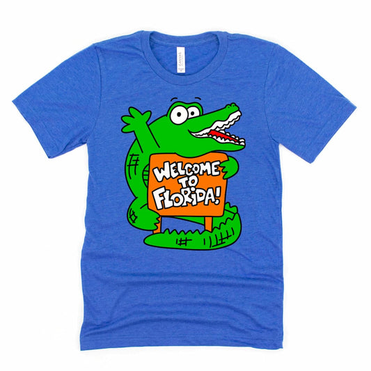 Welcome to Florida Shirt in Heather True Royal Blue with a fun cartoon alligator design, by Kalirally