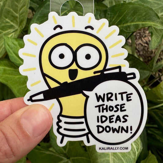 Writer Sticker with cartoon lightbulb and text “Write those ideas down!”, creative ideas decal by Kalirally.